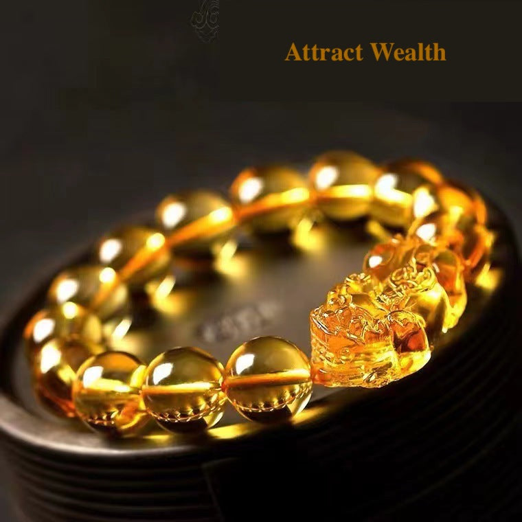 Close-up of golden citrine wealth bracelet with Pixiu talisman