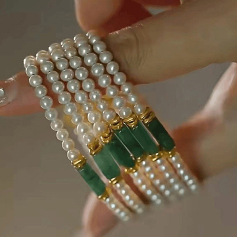 Closeup of natural shell pearls luster and jade center bead