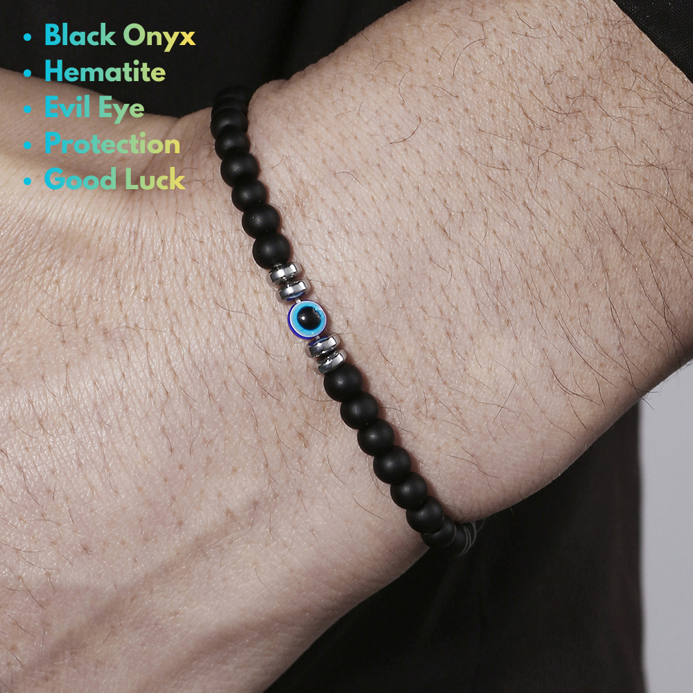 man wearing a blue evil eye bracelet on wrist