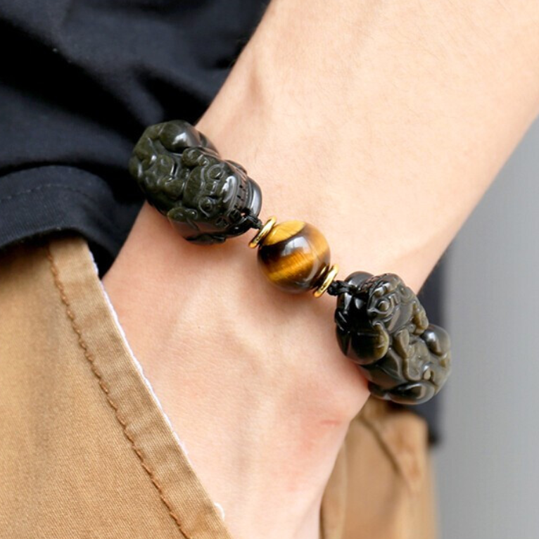 Man wearing a black obsidian Pixiu bracelet on the left wrist