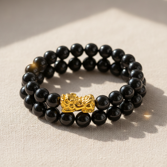 Black obsidian Feng Shui bracelet with a gold Pixiu charm