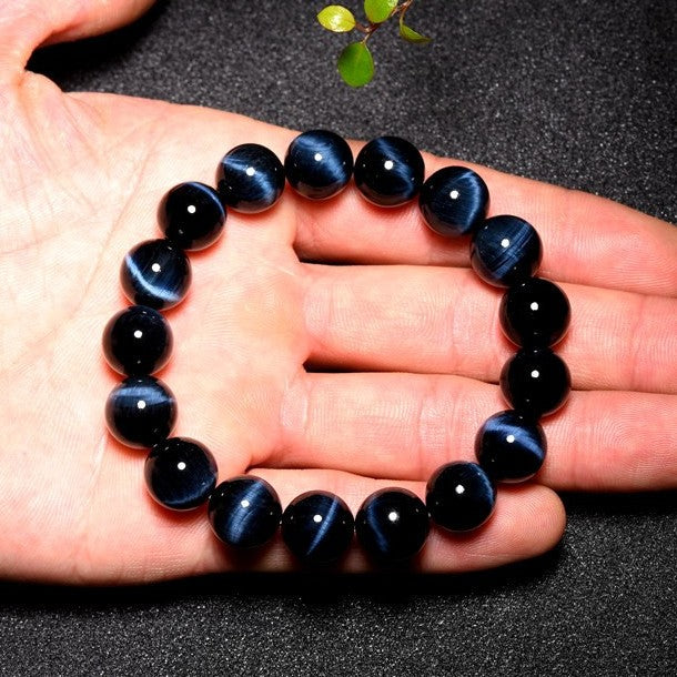 close-up of blue tiger eye beads showing deep-blue glow