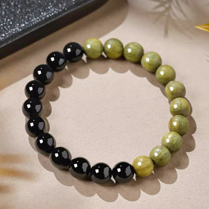 Angled view of Black Obsidian and Green Sandalwood Bracelet showing polished obsidian and natural sandalwood bead sections