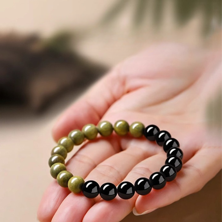 8mm bead detail of Black Obsidian and Green Sandalwood stretch bracelet showing polished obsidian and natural sandalwood texture