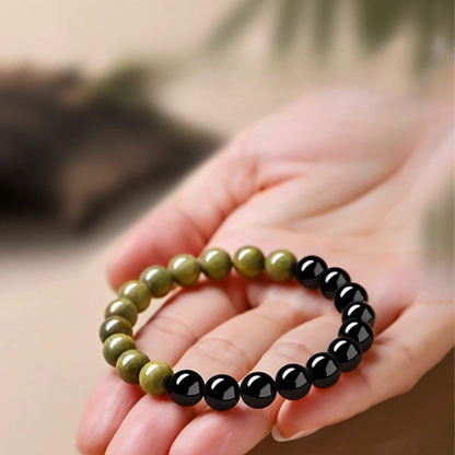 8mm bead detail of Black Obsidian and Green Sandalwood stretch bracelet showing polished obsidian and natural sandalwood texture