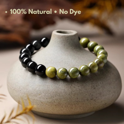 Close-up of the transition between black obsidian and green sandalwood bead sections on a half-and-half gemstone bracelet