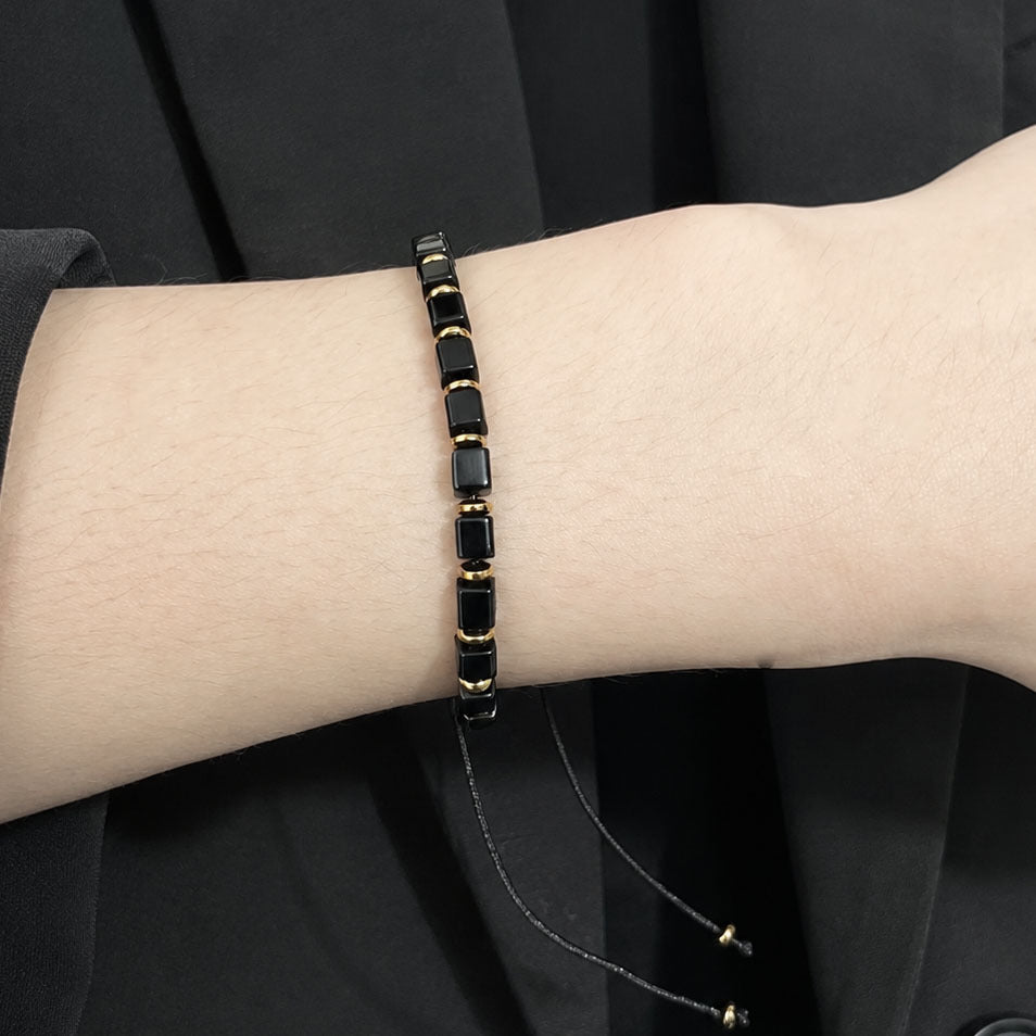 Natural black obsidian protection bracelet with square gemstone beads wear on a wrist