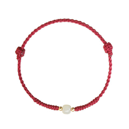 Adjustable handmade red string bracelet with green Hetian jade detail