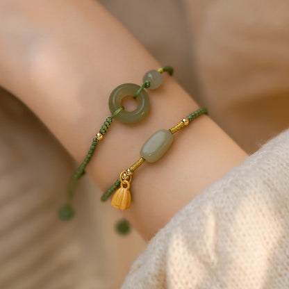 Close-up of green jade donut pendant with smooth polished finish