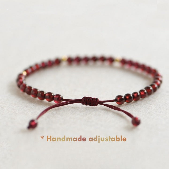 Close-up of 4 mm natural red garnet beads and gold spacers