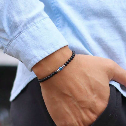 minimalist men’s onyx bead bracelet with blue evil eye charm