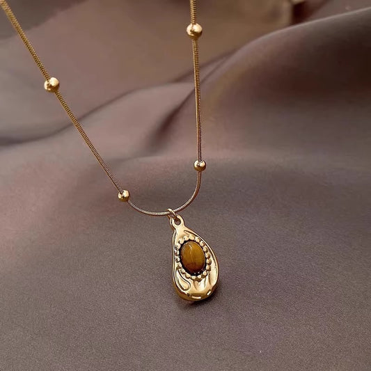Close-up of genuine Tiger’s Eye gemstone pendant – shimmering golden-brown stone