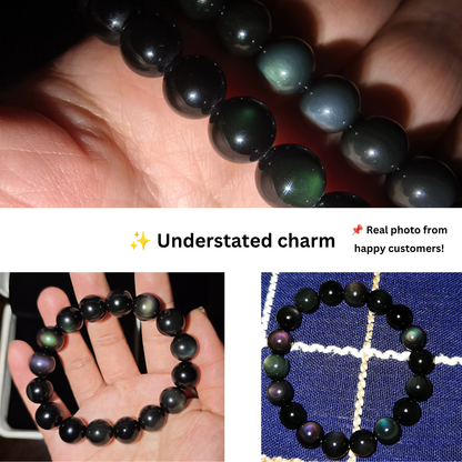Close-up of natural rainbow-eye flash on polished black obsidian gemstone beads