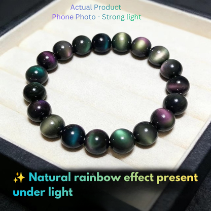 Double-eye rainbow obsidian beads displaying multicolored iridescent flash under light
