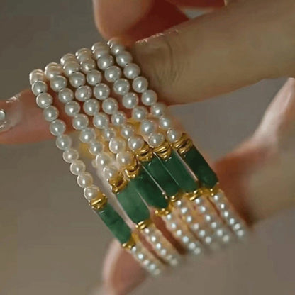 Closeup of natural shell pearls luster and jade center bead